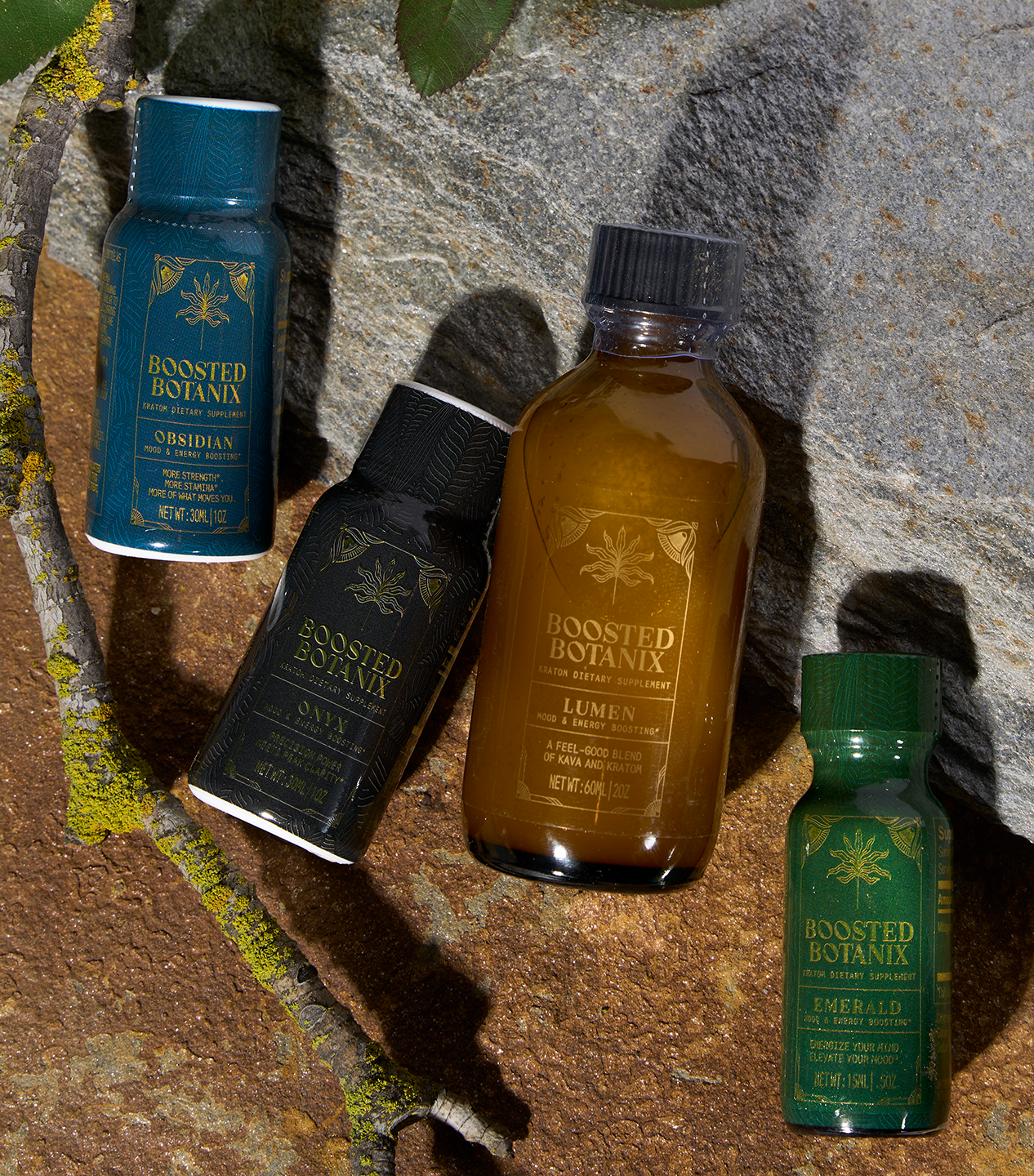 Four bottles of Boosted Botanix products on a stone surface